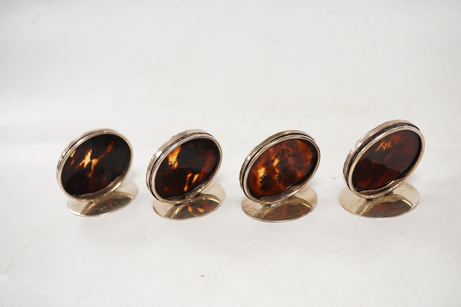 A set of four George V silver and tortoiseshell pique circular menu holders, by William Comyns, Birmingham, 1912/13, height 40mm.